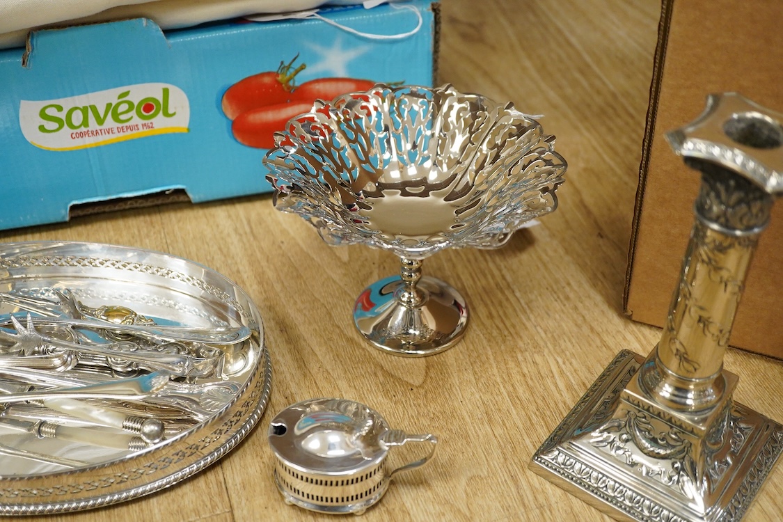 Assorted plated wares including a pair of candlesticks and a casserole dish.